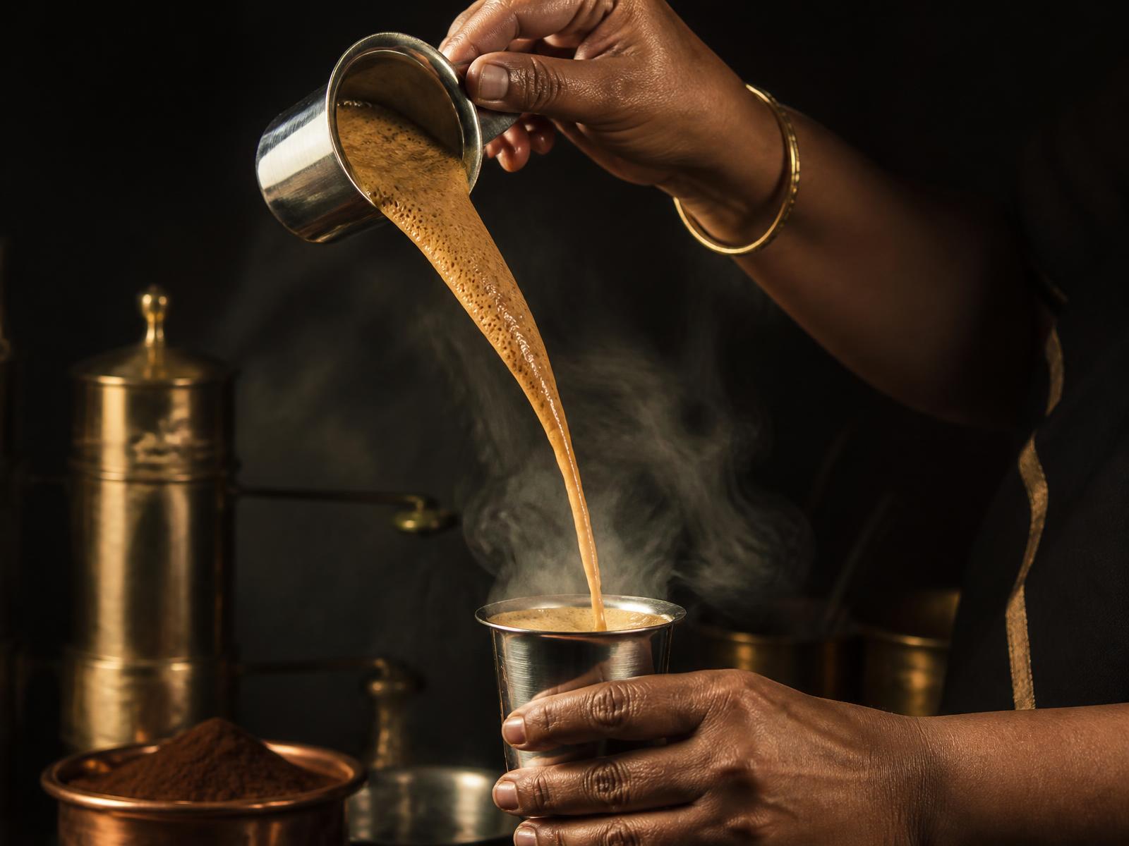 Filter kaapi pulled high between a steel tumbler and dabarah
